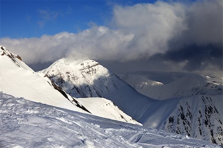 simsearch:400-08530488,k - Off-piste slope and sunlit mountains in clouds. Caucasus Mountains, Georgia, ski resort Gudauri. Stock Photo - Budget Royalty-Free & Subscription, Code: 400-07302680