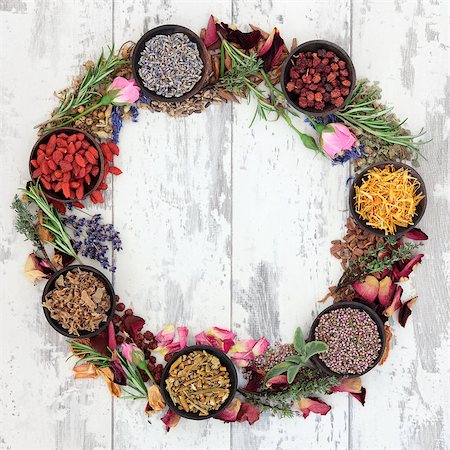 Medicinal herb selection also used in witches magical potions forming a wreath over distressed wooden  background. Stock Photo - Budget Royalty-Free & Subscription, Code: 400-07303171
