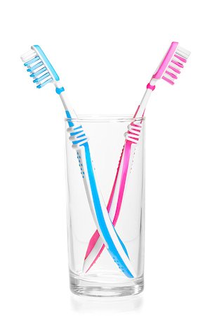 quarreled toothbrushes in a glass on a white background Stock Photo - Budget Royalty-Free & Subscription, Code: 400-07303304