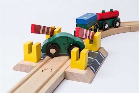 green toy car on railroad crossing with train coming Stock Photo - Budget Royalty-Free & Subscription, Code: 400-07303391
