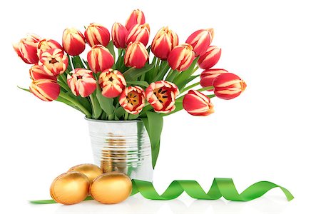 simsearch:6102-03750354,k - Easter egg group with tulip flower arrangement and ribbon curl over white background. Photographie de stock - Aubaine LD & Abonnement, Code: 400-07303455