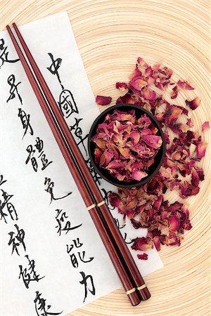 simsearch:400-07175956,k - Chinese herbal medicine rose flower petals with  mandarin calligraphy script on rice paper describing the medicinal functions to maintain body and spirit health and balance body energy. Stock Photo - Budget Royalty-Free & Subscription, Code: 400-07303607