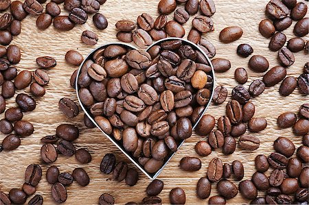 coffee beans as background from good roasted coffee beans with heart shaped metal frame Stock Photo - Budget Royalty-Free & Subscription, Code: 400-07303645