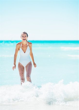 simsearch:400-06639191,k - Happy young woman playing with waves on beach Stock Photo - Budget Royalty-Free & Subscription, Code: 400-07303967