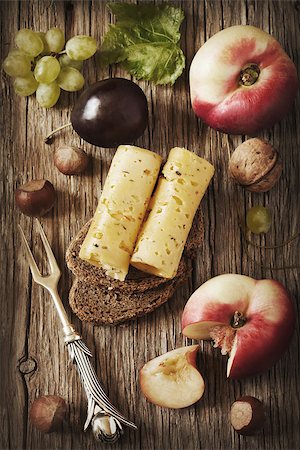 simsearch:400-04184502,k - Delicious cheese on a rye bread with fruit and nuts on a wooden board. Stock Photo - Budget Royalty-Free & Subscription, Code: 400-07314778