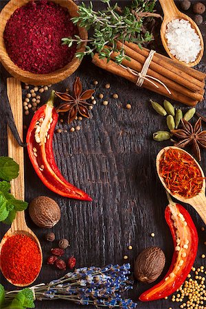 simsearch:400-08053136,k - Colorful spices and herbs frame on a wooden background. Photographie de stock - Aubaine LD & Abonnement, Code: 400-07314787