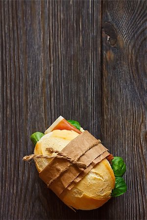 slice of baguette - Sandwich on a wooden background with copy space for text. Foto de stock - Super Valor sin royalties y Suscripción, Código: 400-07314796