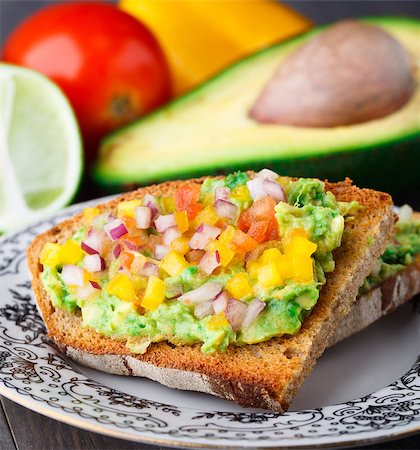 sandwich with avocado - Delicious vegetarian sandwich with avocado and vegetables Stock Photo - Budget Royalty-Free & Subscription, Code: 400-07315505
