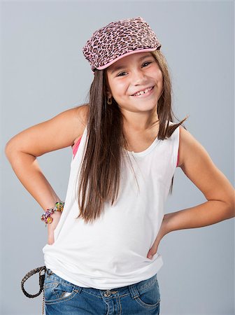 smiling young latina models - Beautiful young latino brunette female child with long hair posing in studio isolated on a blue background Foto de stock - Super Valor sin royalties y Suscripción, Código: 400-07315560