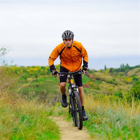 Cyclist Riding the Bike on the Beautiful Spring Mountain Trail Stock Photo - Budget Royalty-Free & Subscription, Code: 400-07316040