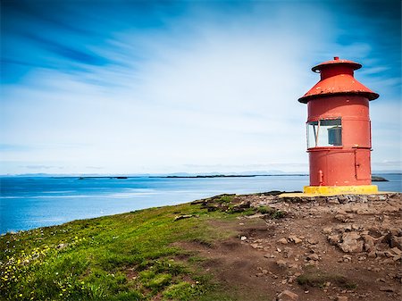 simsearch:400-04083138,k - Little red lighthouse situated at the top of a cape over a sunny seascape. Related concept: navigation, help, aid, guide. Sykkisholmur, Iceland, Europe. Foto de stock - Super Valor sin royalties y Suscripción, Código: 400-07316171