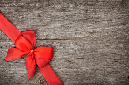Wooden background with red bow and ribbon with copy space Stock Photo - Budget Royalty-Free & Subscription, Code: 400-07316781
