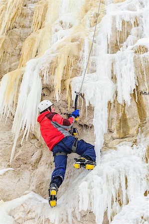 Young man climbing the ice using ice axe Stock Photo - Budget Royalty-Free & Subscription, Code: 400-07317111