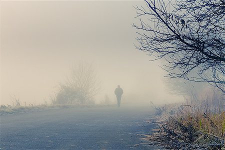 disappear - A person walk into the misty foggy road in a dramatic sunrise scene with abstract colors Stock Photo - Budget Royalty-Free & Subscription, Code: 400-07317178