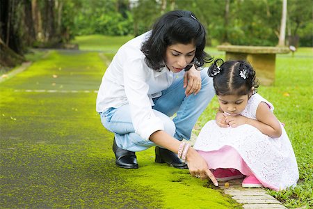 Indian family outdoor activity. Candid portrait of mother and daughter exploring on nature, outdoors education. Stock Photo - Budget Royalty-Free & Subscription, Code: 400-07318224