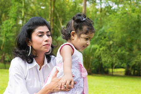 Happy Indian family at garden park. Portrait of a mother helping baby girl to walk outdoor. Stock Photo - Budget Royalty-Free & Subscription, Code: 400-07318240