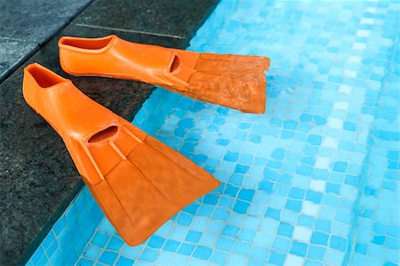 simsearch:400-05130106,k - Orange Rubber flippers on the side of the swimming pool Stock Photo - Budget Royalty-Free & Subscription, Code: 400-07318525