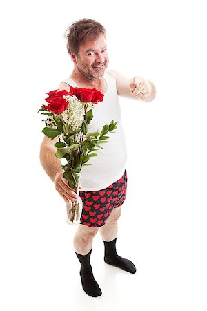 Scruffy looking guy in his underwear with too much confidence holding a vase of red roses and pointing at you. Full body isolated on white. Stock Photo - Budget Royalty-Free & Subscription, Code: 400-07318701