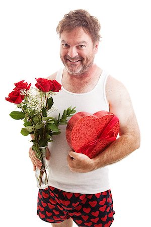 Humorous photo of a scruffy looking middle aged man in his underwear holding a bouquet of roses and a box of Valentines day candy for his sweetie. Isolated on white. Stock Photo - Budget Royalty-Free & Subscription, Code: 400-07318703