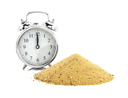 Alarm clock with pile of sand  of white background, passing of time concept Photographie de stock - Aubaine LD & Abonnement, Code: 400-07318907