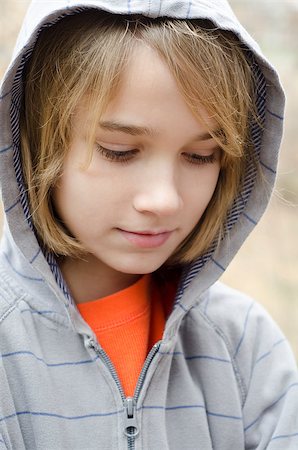 You preteen boy wearing a hoodie and feeling down Stock Photo - Budget Royalty-Free & Subscription, Code: 400-07319322