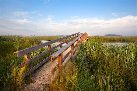 long wooden bridge for bicycles over river in morning Stock Photo - Budget Royalty-Free & Subscription, Code: 400-07319628