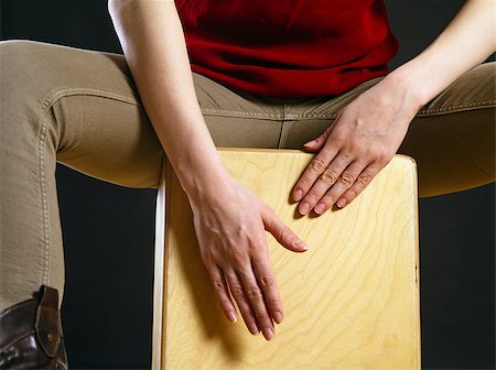 Closeup photo of a woman playing a Cajon percussion instrument. Stock Photo - Budget Royalty-Free & Subscription, Code: 400-07310009