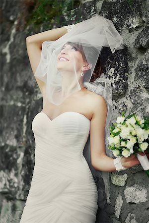 Beautiful bride playing with veil.  Summertime picture. Stock Photo - Budget Royalty-Free & Subscription, Code: 400-07311901