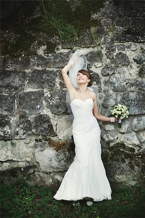 Bride playing with veil against rock wall. Stock Photo - Budget Royalty-Free & Subscription, Code: 400-07311902