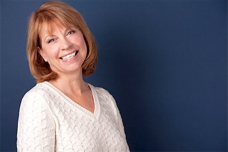 mature woman wearing white sweather on dark blue background Fotografie stock - Microstock e Abbonamento, Codice: 400-07312710