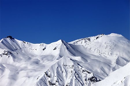 simsearch:400-07222348,k - Off piste snowy slope and blue clear sky. Caucasus Mountains, Georgia, ski resort Gudauri. Fotografie stock - Microstock e Abbonamento, Codice: 400-07313678