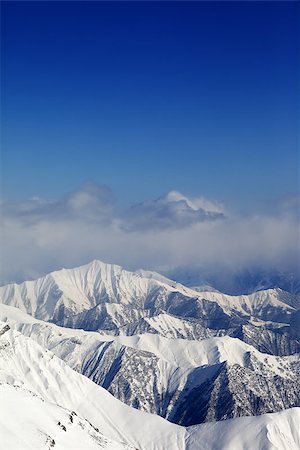 simsearch:400-08530488,k - Winter snowy mountains and blue sky with clouds. Caucasus Mountains, Georgia, view from ski resort Gudauri. Stock Photo - Budget Royalty-Free & Subscription, Code: 400-07313730