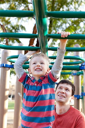 school playground - little positive boy at the monkey bars and his father watching and helping Stock Photo - Budget Royalty-Free & Subscription, Code: 400-07313868