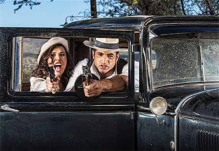 1920s vintage gangsters in shoot out behind car door Stock Photo - Budget Royalty-Free & Subscription, Code: 400-07313979