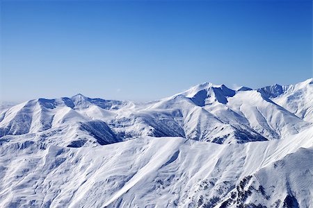 simsearch:400-07222348,k - Snowy winter mountains and blue sky, view from ski slope. Caucasus Mountains, Georgia, ski resort Gudauri. Fotografie stock - Microstock e Abbonamento, Codice: 400-07324150