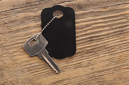 Blank tag and a key on wooden background Stock Photo - Budget Royalty-Free & Subscription, Code: 400-07324306