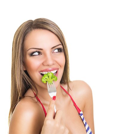 simsearch:400-04402342,k - Closeup studio shot of a happy smiling young Caucasian blonde woman eating broccoli isolated on white background. Stock Photo - Budget Royalty-Free & Subscription, Code: 400-07324418