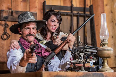 simsearch:400-07516134,k - Smiling Sheriff Stands With Woman and a Loaded Gun Stock Photo - Budget Royalty-Free & Subscription, Code: 400-07324724