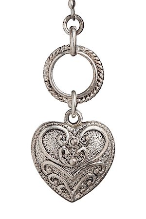 silver heart pendant with ornate design on white background Stock Photo - Budget Royalty-Free & Subscription, Code: 400-07325172