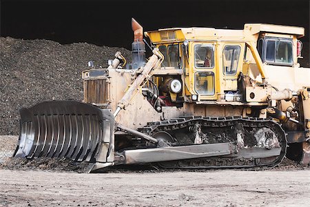 Bulldozer machine doing earth moving work in construction site Stock Photo - Budget Royalty-Free & Subscription, Code: 400-07325602