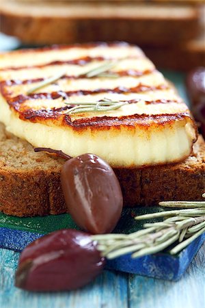 simsearch:400-07260354,k - Grilled cheese, olives, rosemary on blue table. Stockbilder - Microstock & Abonnement, Bildnummer: 400-07326050