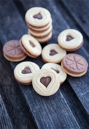 Heart shaped cut out cookies with chocolate filling on the wooden table Stock Photo - Budget Royalty-Free & Subscription, Code: 400-07326083