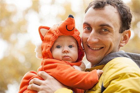 people animal cuddle - Young Caucasian man and his little son in fox costume in autumn park Stock Photo - Budget Royalty-Free & Subscription, Code: 400-07326150