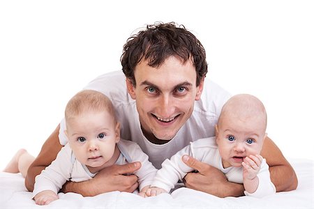 simsearch:400-07329323,k - Smiling young man with two baby boys over white Foto de stock - Royalty-Free Super Valor e Assinatura, Número: 400-07326161