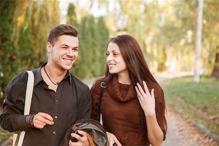 young couple walking in park talking smiling Stock Photo - Budget Royalty-Free & Subscription, Code: 400-07327349