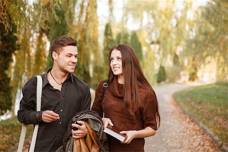 young couple walking in park talking smiling Stock Photo - Budget Royalty-Free & Subscription, Code: 400-07327351