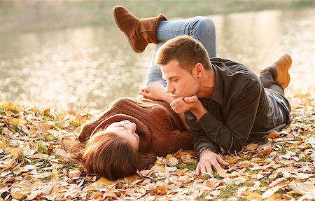 young male and female lying down near lake talking Stock Photo - Budget Royalty-Free & Subscription, Code: 400-07327365