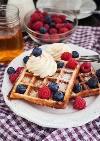 simsearch:400-07917638,k - Breakfast with belgian waffles decorated with whipped cream and fresh berries Stock Photo - Budget Royalty-Free & Subscription, Code: 400-07328049