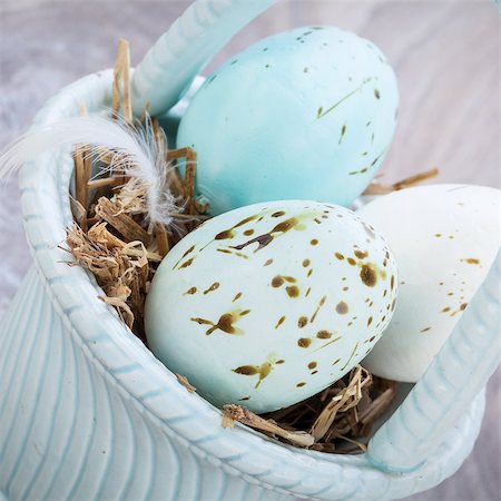 easter basket not people - Three natural blue dyed Easter eggs in a basket with a single bird feather for a rustic seasonal celebration symbolic of the resurrection of Christ Foto de stock - Super Valor sin royalties y Suscripción, Código: 400-07328502