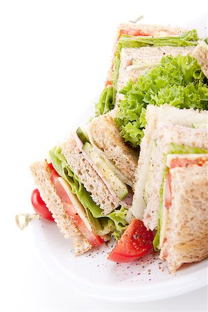 fresh tasty club sandwich with lettuce cheese ham and toast isolated on white background Foto de stock - Super Valor sin royalties y Suscripción, Código: 400-07328553